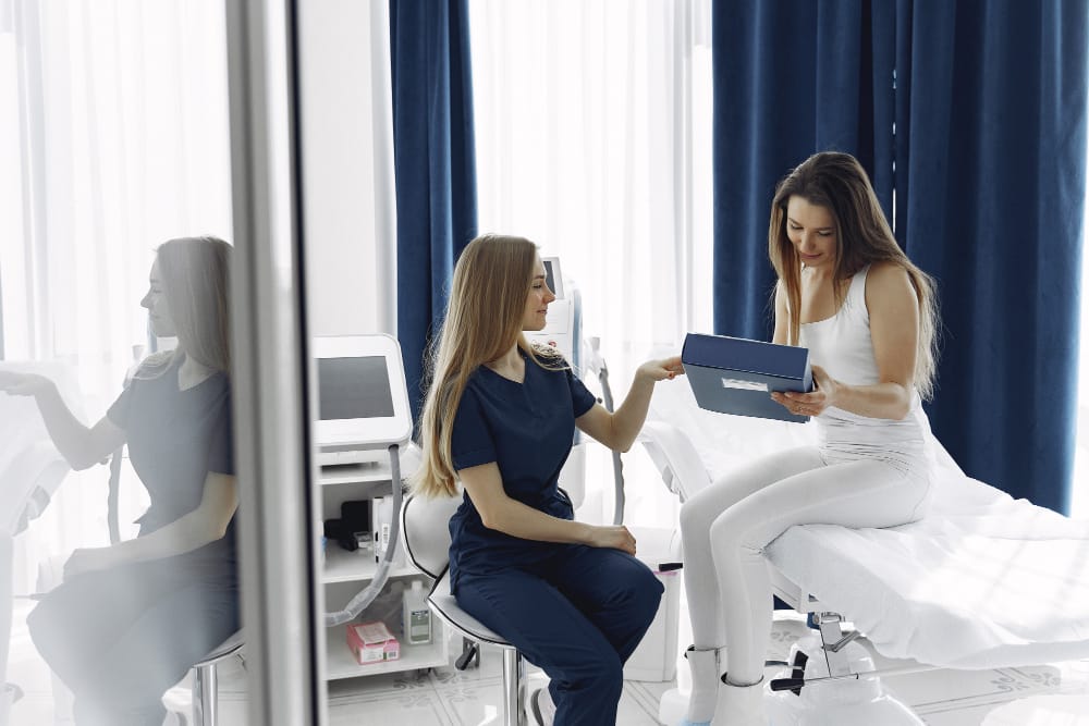 Medical spa practitioner consulting with client in treatment room