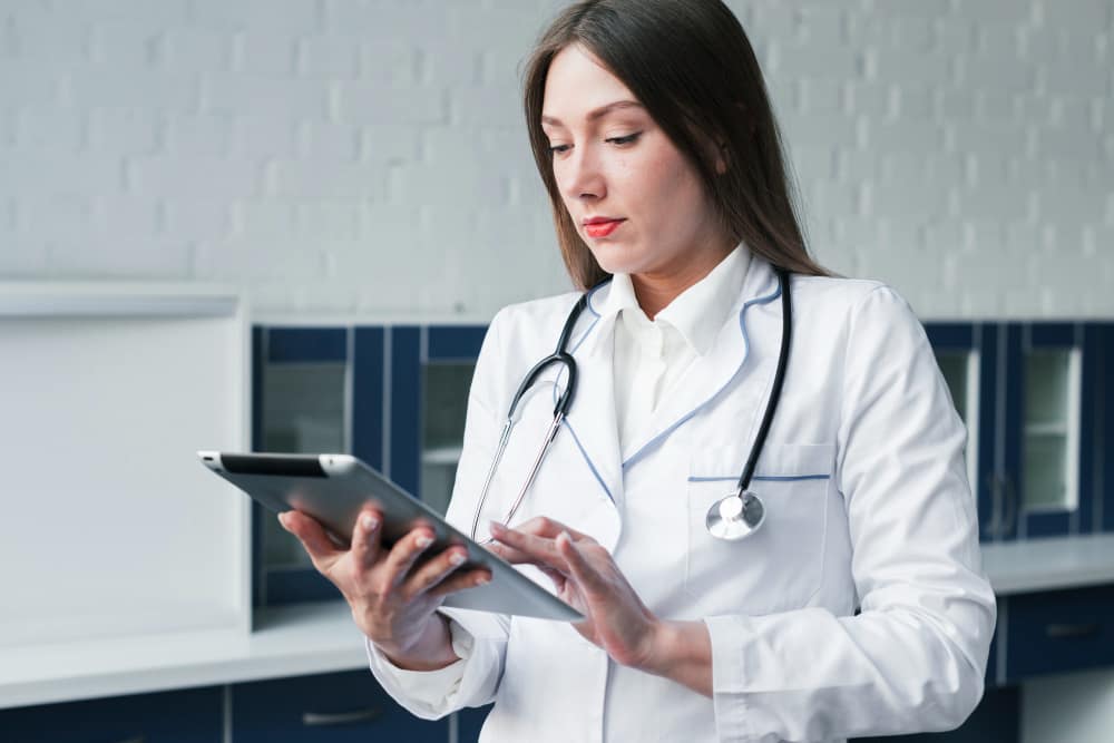 Female doctor using tablet for electronic patient records