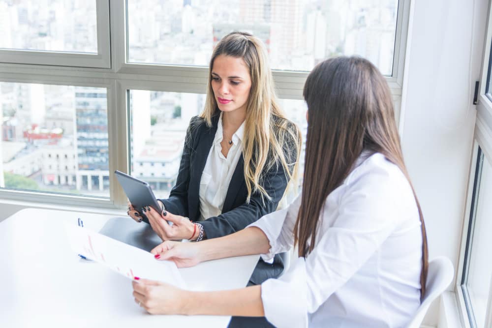 Female attorney consulting with healthcare professional about business formation options