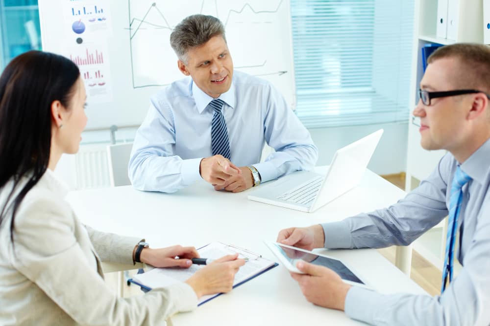 Business advisor consulting with healthcare professionals about practice formation and compliance