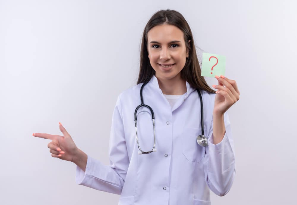 Healthcare professional in white coat holding question mark card about business decisions