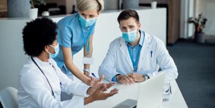 Group Medical Experts Talking While Using Laptop Meeting Hospital