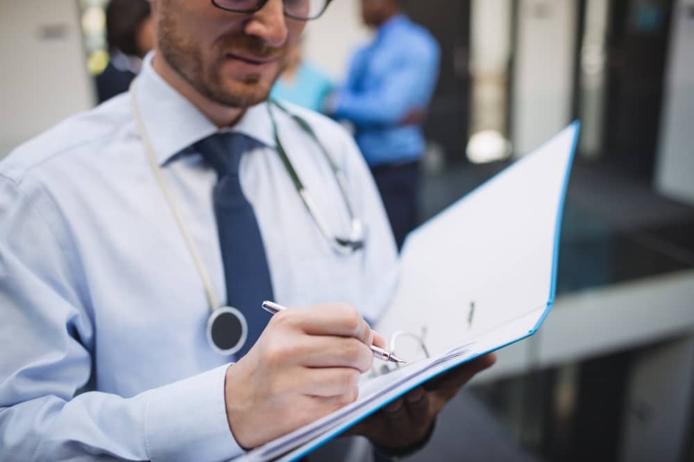 Doctor reviewing and signing employment contract documents