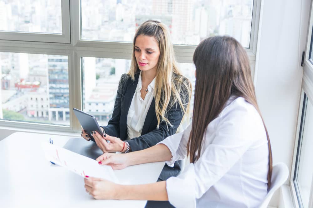 Female attorney consulting with healthcare professional about business formation options