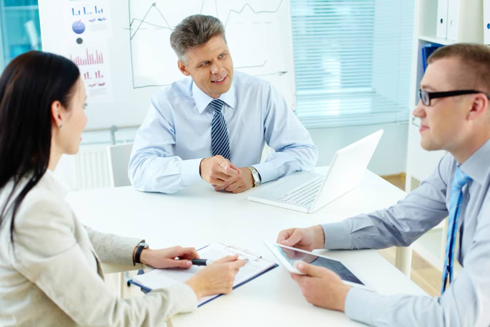 Business advisor consulting with healthcare professionals about practice formation and compliance